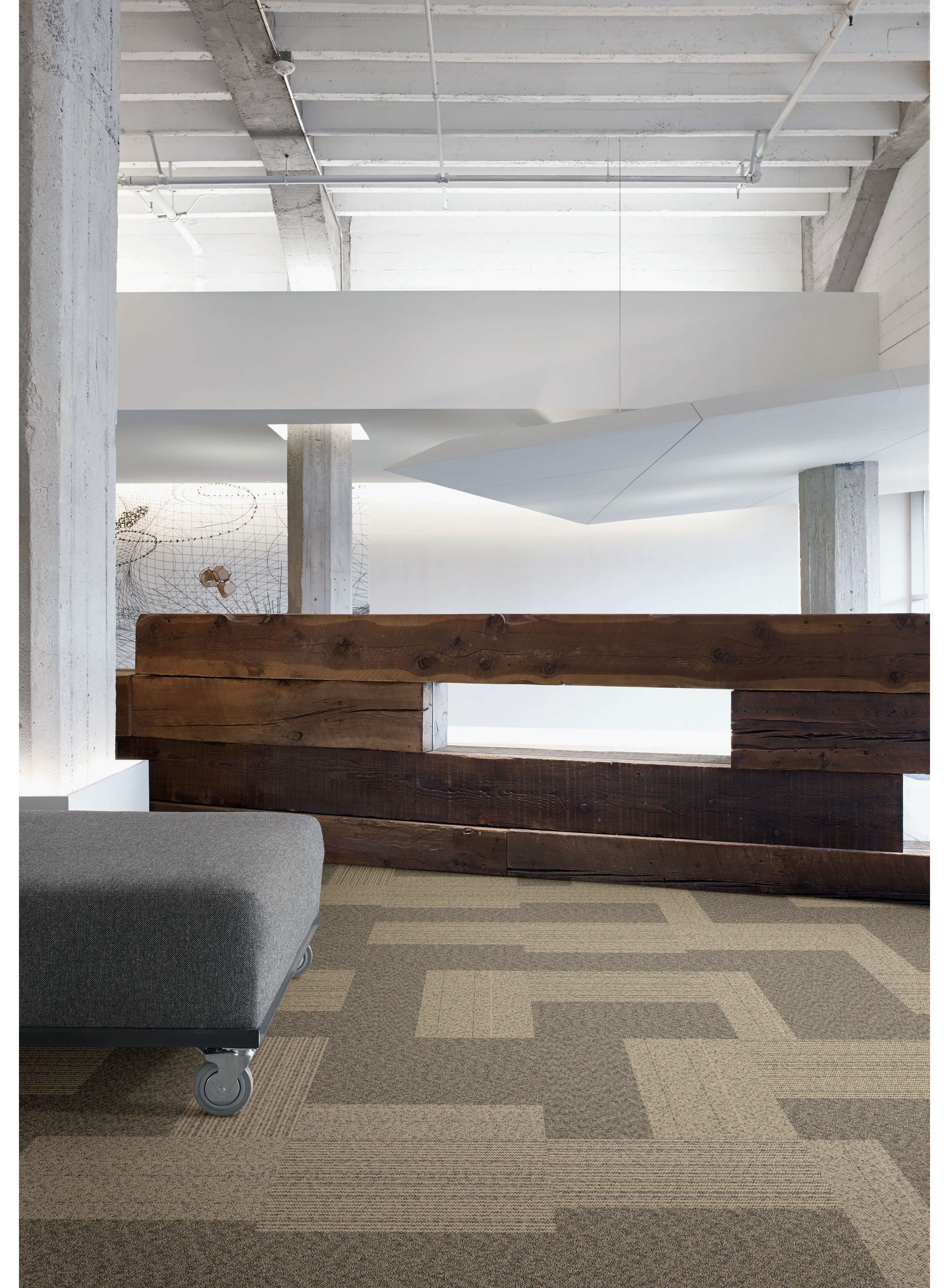 Interface ShadowBox Loop carpet tile in office common area with wooden wall and bench imagen número 1